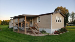 A single-story house with a covered porch and a small staircase leading to the front door. - Randy's Rathbun Rental.  "Your Home Away From Home"  Fully Furnished Sleeps 6 (Moravia)