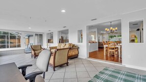 A spacious living area with a sofa, armchairs, and a dining table. - Sarasota Waterfront Paradise- Location, Location...!!
 (Sarasota)