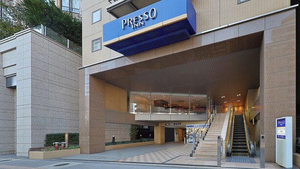 A modern hotel entrance with a prominent signage, a staircase leading to the entrance, and a clear view of the interior. - Keio Presso Inn Shinjuku (Tokyo)