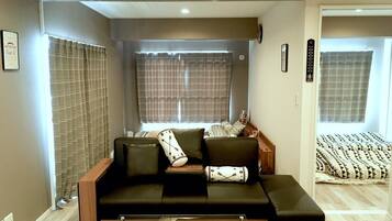 Plum Ark Apartment 402 | Living area | Flat-screen TV