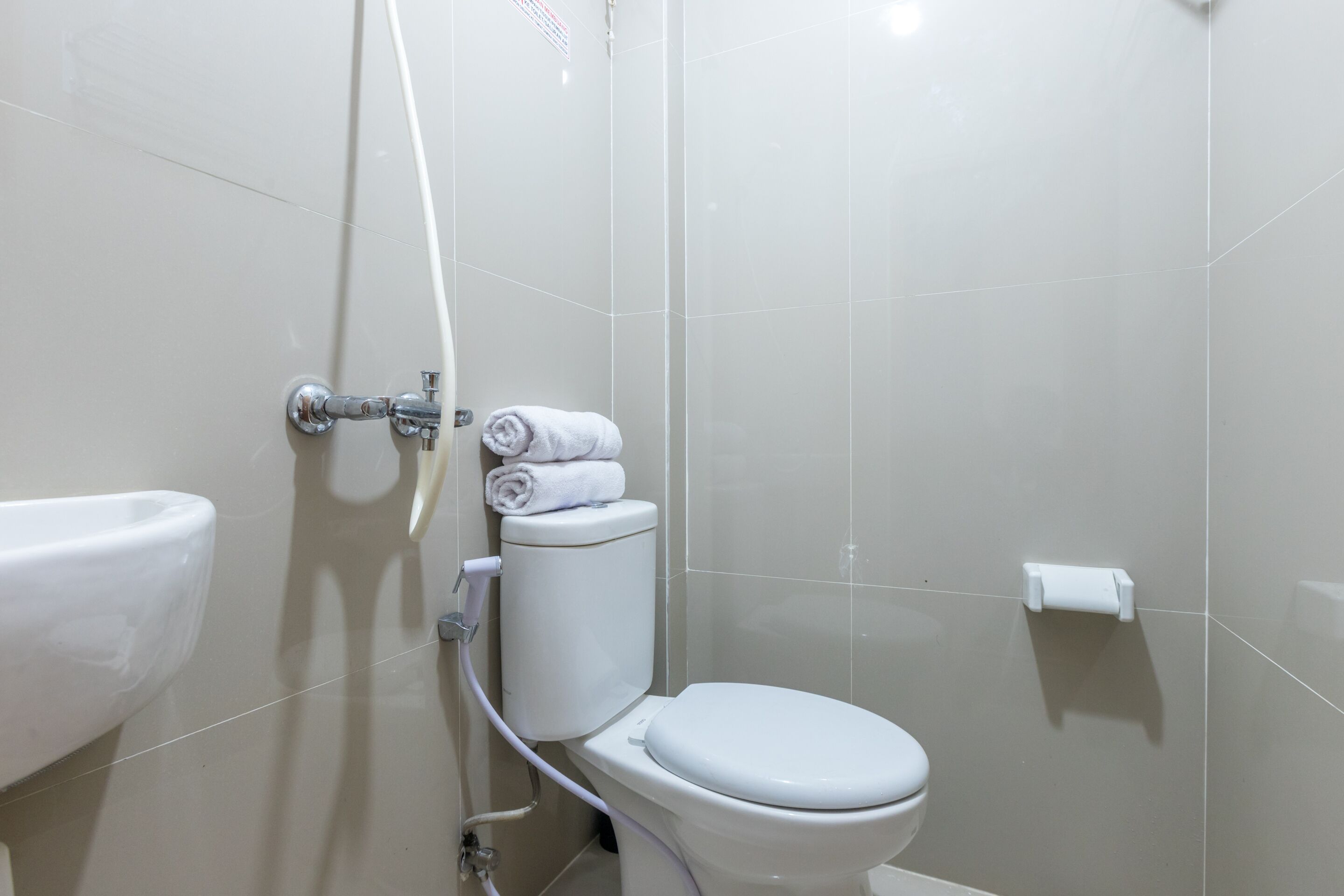 A bathroom with a toilet, a sink, and a shower.