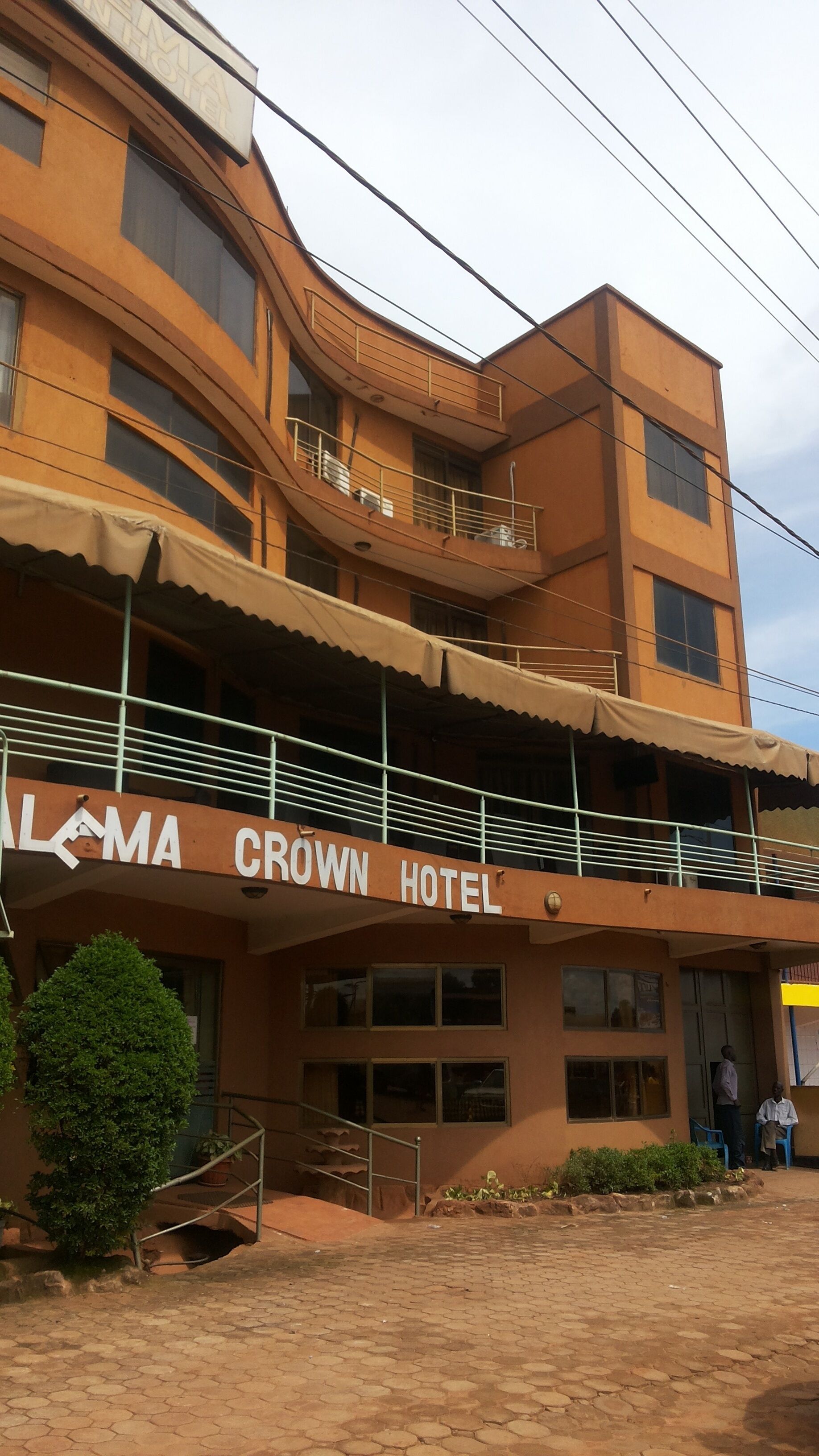 A building with a sign reading "ALMA CROWN HOTEL".