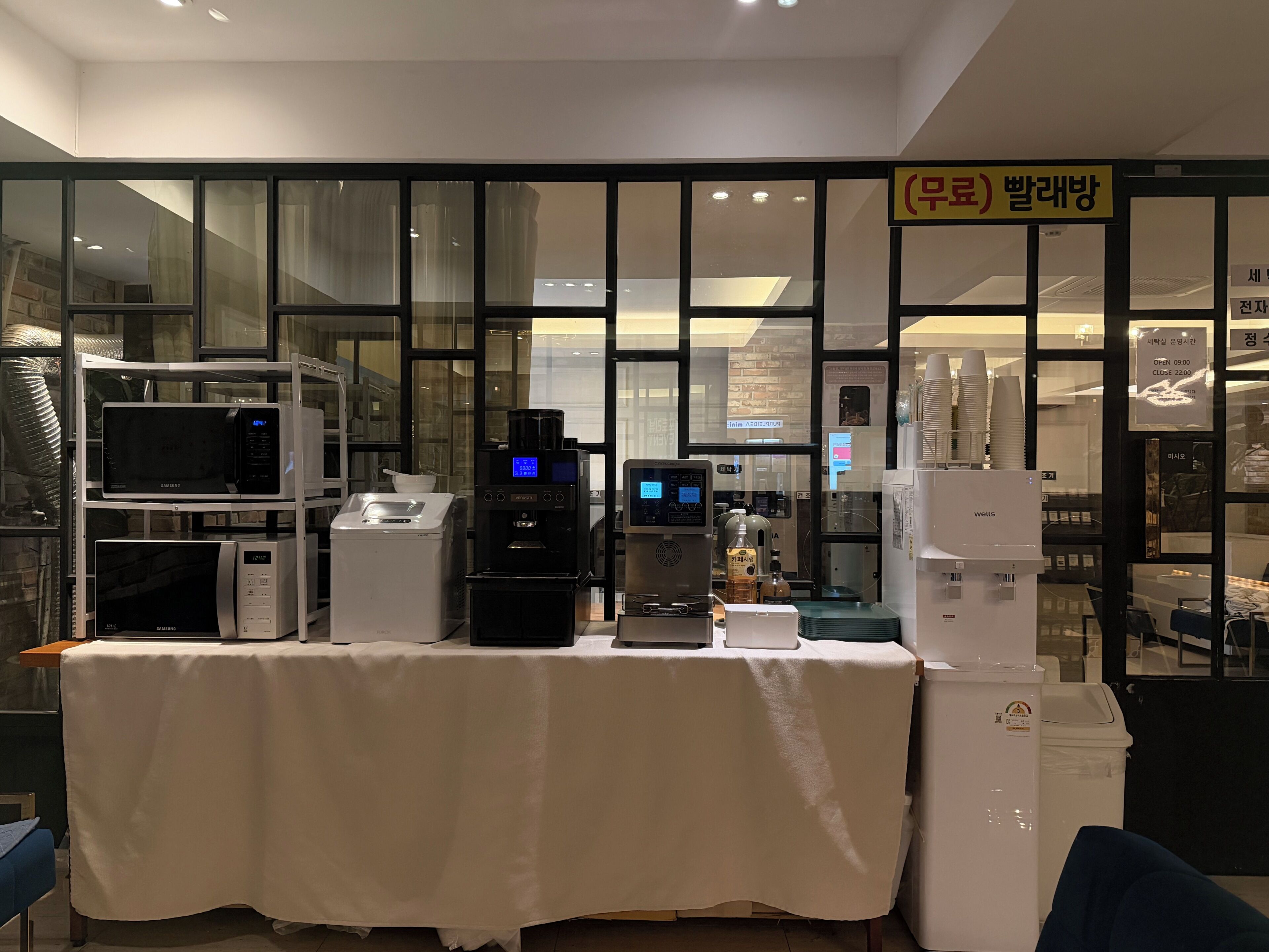A kitchen area with appliances like a microwave, coffee machine, and refrigerator.