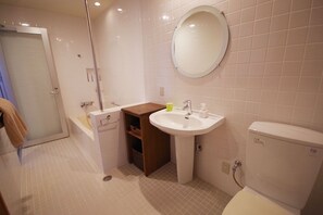A bathroom with a white sink, mirror, and toilet. - Resort in Villa Yamabare (Ishigaki)