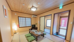 A traditional Japanese room with tatami flooring, a low table with a tea set, and sliding doors. - Yadoya Hakutei-An (Tokyo)