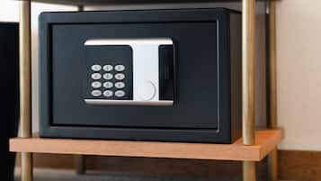 A black safe with a keypad on a wooden stand.