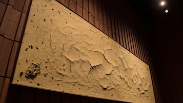 Una pared con textura, pintura descascarada y diseño de listones de madera.