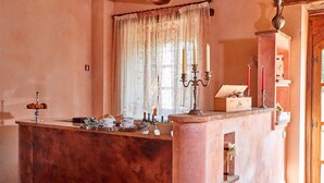 A cozy room with a marble counter, a window with sheer curtains, and a wooden door. - In the middle of nature Apartment. Fireplace and Olives trees view. Zaffiro (Spoleto)