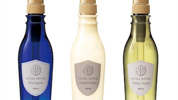 Three bottles of ESTHE ROYER products: shampoo, conditioner, and body soap.