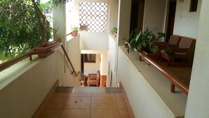A staircase leading to a lower level with a view of a balcony area. - Zawadi Hotel (Adjumani)