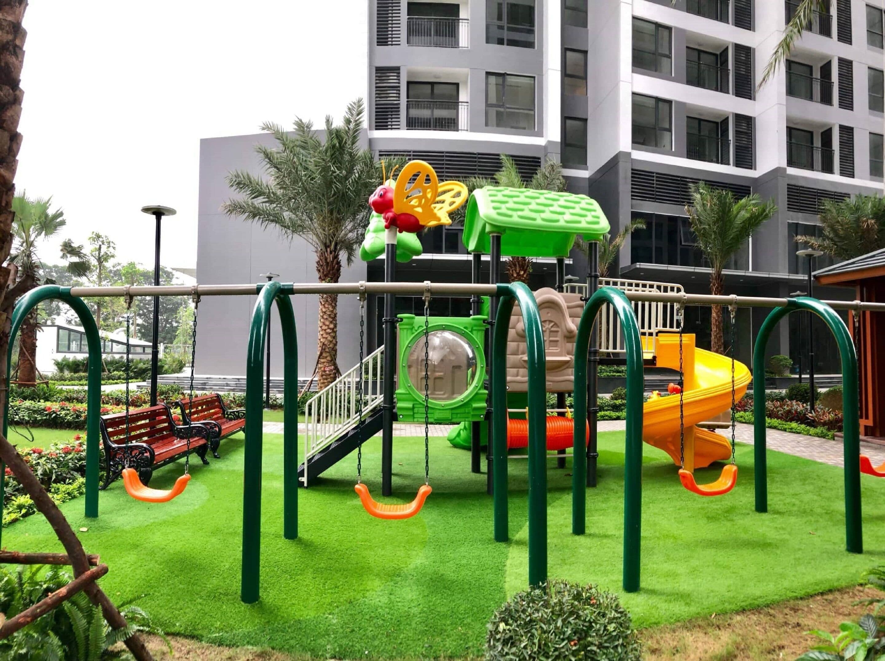 A playground with swings, a slide, and a climbing structure.