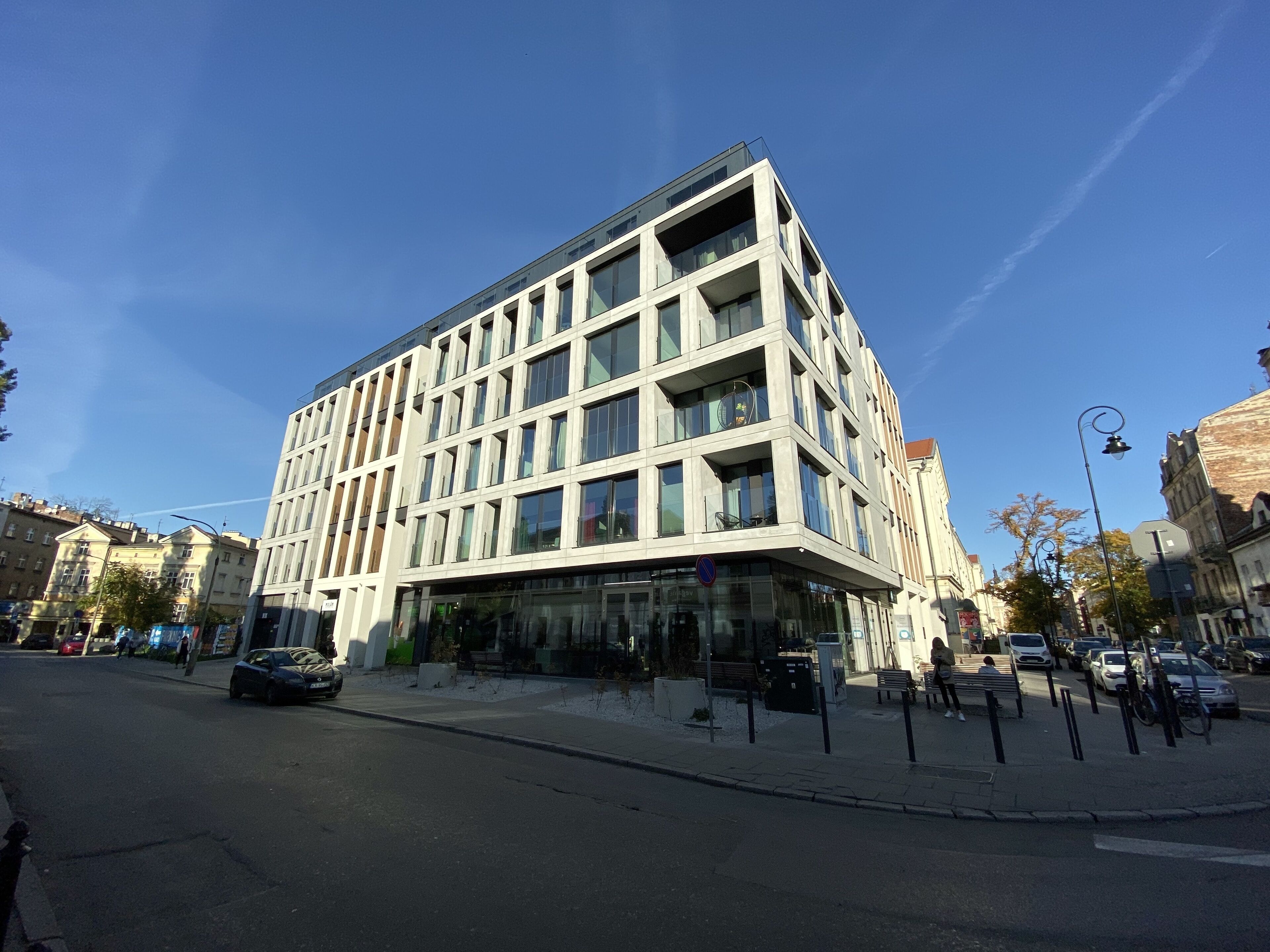 A modern multi-story building with large windows and a flat roof.