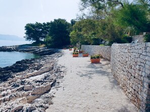 Privat strand, solsenger, parasoller og snorkling