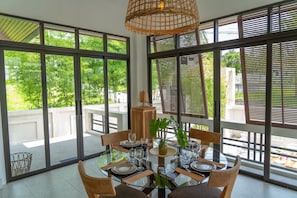 Enjoy meals with family and friends in this dining area, featuring a round table and comfortable seating for four.