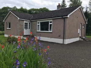A two-story house with a stone facade, a tiled roof, and a gravel driveway. - Cliff View, Free Parking, Free WiFi, (Perth)