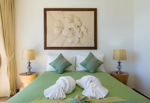 A neatly made bed with green bedding, two pillows, and two bedside lamps. -  The Heights Penthouse Ocean view A11 Near Kata Beach (Karon)