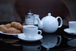 A table with a teapot, cups, and pastries. - Boutique Living Hotel (Yerevan)