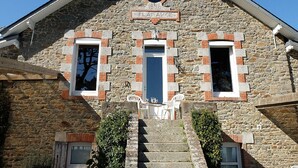 A stone building with a sign reading "PLAISANCE" and a small circular window above the entrance. - charming villa, exceptional sea view, with tuned piano, 6-8 people. (Saint-Nazaire)