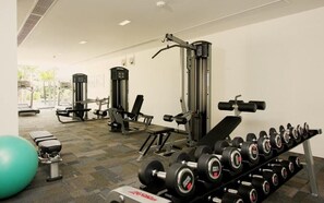 A gym with various exercise equipment, including dumbbells, benches, and weight machines. -  The Heights Kata Seaview C1 near Kata Beach (Karon)