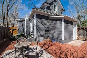 A house with a garage, a covered patio, and a fenced yard. - 3 BR Beautifully Restored 1890`s Homedowntown (Colorado Springs)