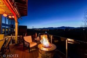 A deck with a stone fire pit, outdoor seating, and a view of the mountains. - 5BR Mtn Views Family Getaway HOT TUB (Colorado Springs)