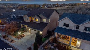 A residential area with houses featuring sloped roofs, visible garages, and landscaped yards. - 5BR Mtn Views Family Getaway HOT TUB (Colorado Springs)
