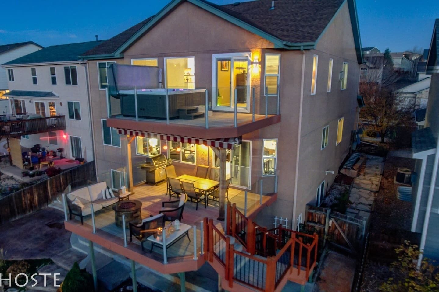 A two-story house with a balcony and a patio area.