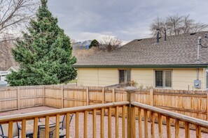 A house with a fenced backyard, a wooden deck, and a large evergreen tree. - 4BR Dog Friendlygarden of the Godsbbq Grill! (Colorado Springs)