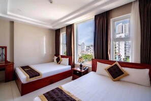 A hotel room with two beds, a desk, and a large window with a city view. - Dubai Hotel (Da Nang)