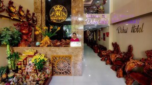 A reception area with a sign reading "Welcome to Dubai Hotel" and a receptionist. - Dubai Hotel (Da Nang)