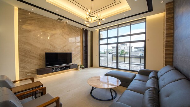 A modern living room with a large TV, comfortable seating, and a view of the outside. - Yilan Siao Jhu (Jiaoxi)