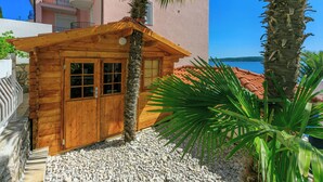 A wooden cabin with a stone foundation, a wooden door, and windows. - House Blanka (Dramalj)