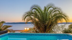A swimming pool with a view of the sea at sunset. - House Blanka (Dramalj)
