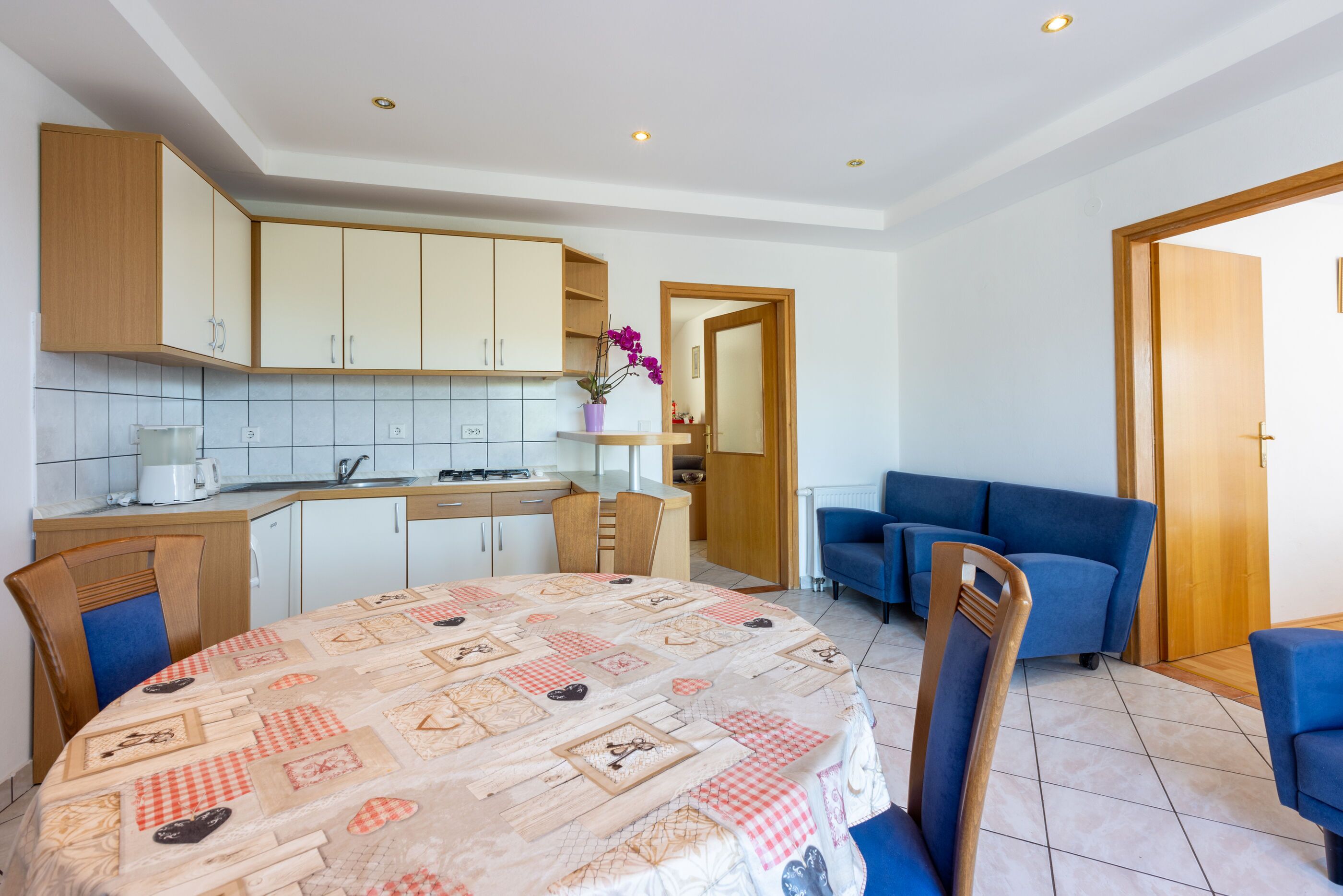 A compact living space with a kitchen, dining area, and seating area.
