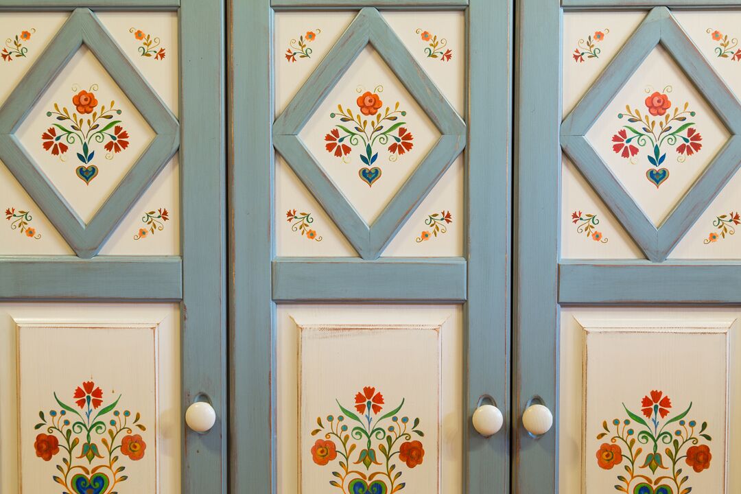 A set of doors with floral designs and heart motifs.