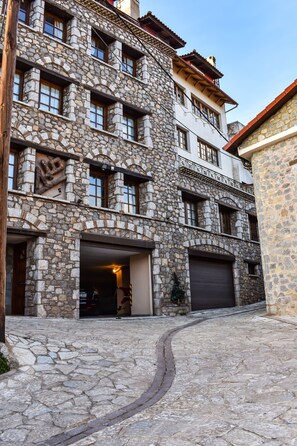 Un edificio de piedra con varias ventanas y un garaje.