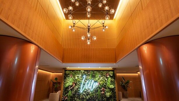 A lobby with a wooden ceiling, a neon sign reading "Life," and a wall of greenery. - The OneFive Villa Fukuoka (Fukuoka)