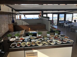 A buffet with various dishes and potted plants. - Mehmet Bey Suites (Istanbul)