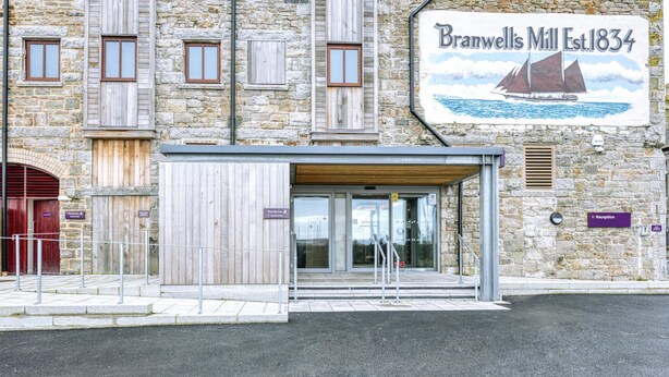 A stone building with a sign reading 'Branwell's Mill Est. 1834' and a covered entrance. - Premier Inn Penzance (Penzance)
