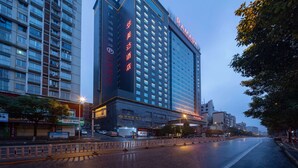 A high-rise hotel with a prominent sign, multiple floors, and a modern architectural design.