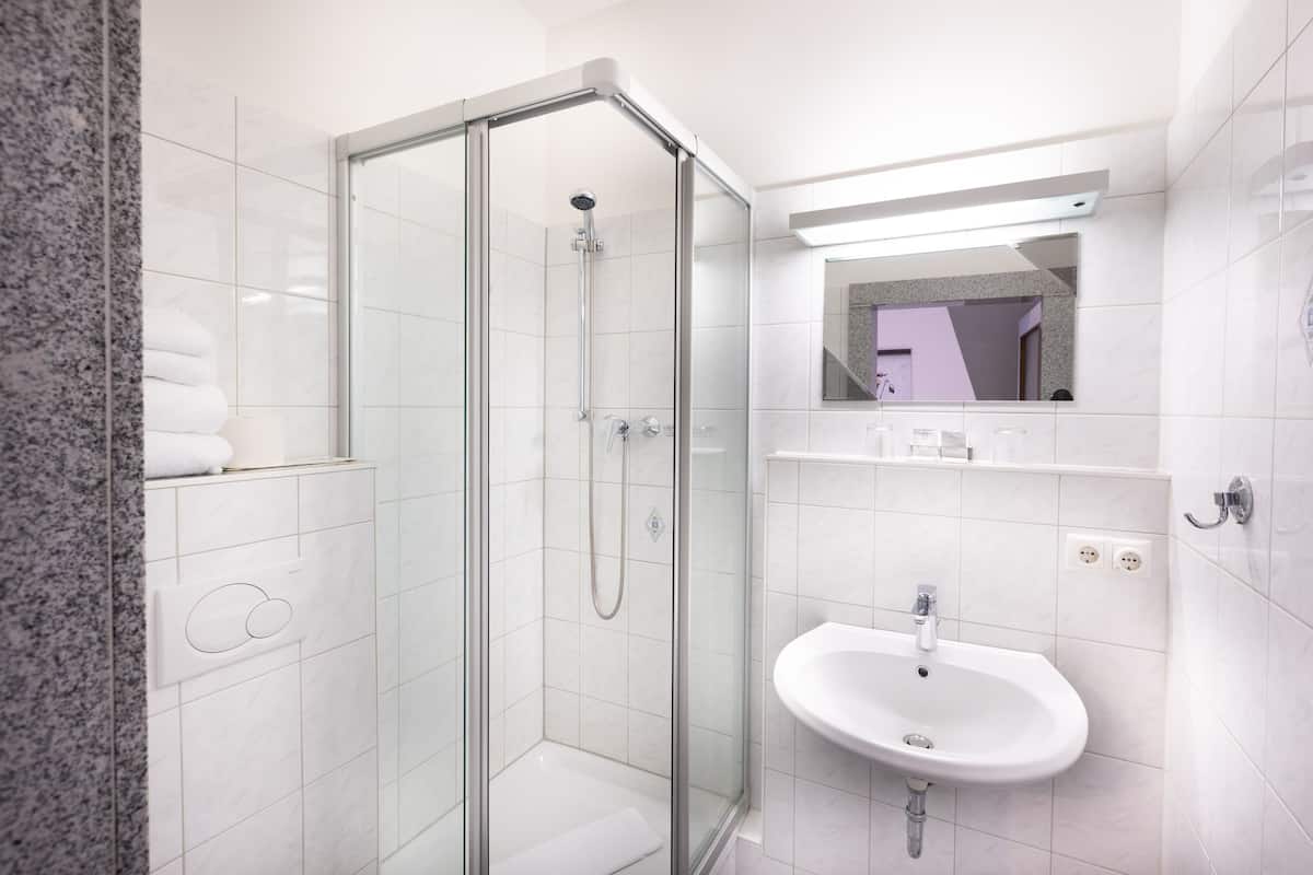 standard triple room | bathroom | shower, hair dryer, towels, soap