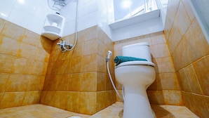A bathroom with a toilet, a urinal, and a shower head. - Furnished Studio Green Pramuka City Apartment (Jakarta)
