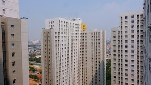 A high-rise building with multiple floors, featuring a uniform facade and numerous windows.
