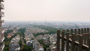 A residential area with multiple houses and a distant view of a cityscape.
