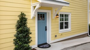 A yellow house with a blue door, a small window, and a mailbox. - The Carlton* 3 min walk to Downtown Mt. Dora!!  (Mt Dora)