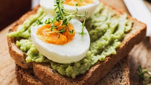 A sandwich with avocado spread and a boiled egg on a slice of bread. - PLLAZIO Residency (Gurugram)