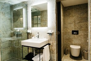 Deluxe Room | Bathroom | Designer toiletries, hair dryer, bathrobes, slippers