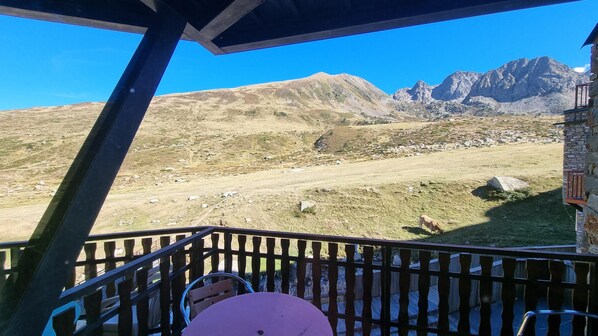 A balcony with a view of a mountainous landscape.