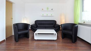 Apartment, 1 Bedroom (Polaris) | Living room | Flat-screen TV