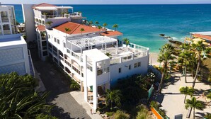 A multi-story hotel with balconies overlooking the ocean.